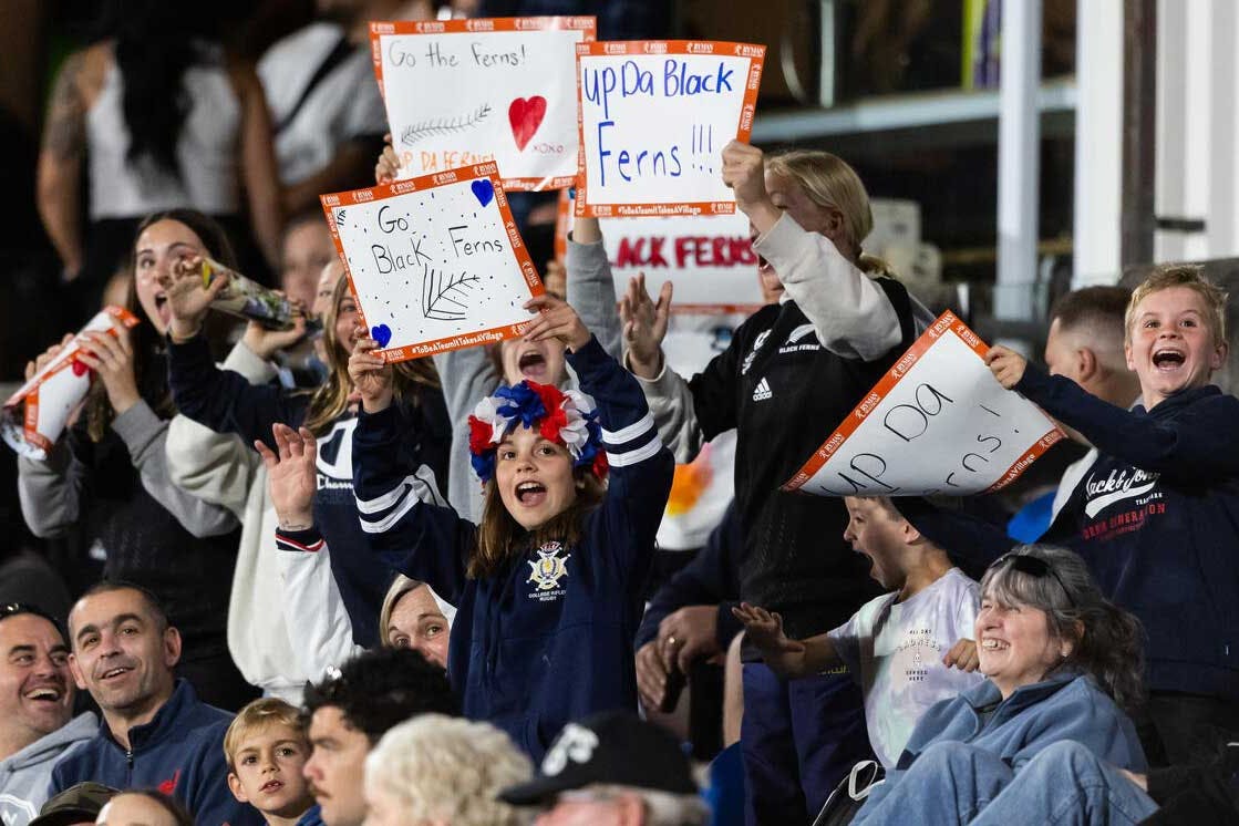 Kids celebrating in the crowd of a Black Ferns match